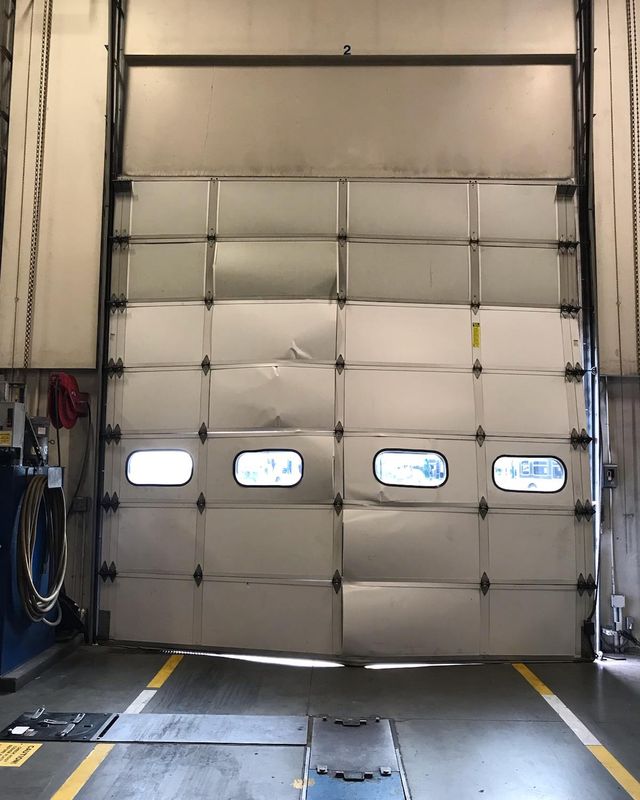 The same crushed dock door seen from inside the building