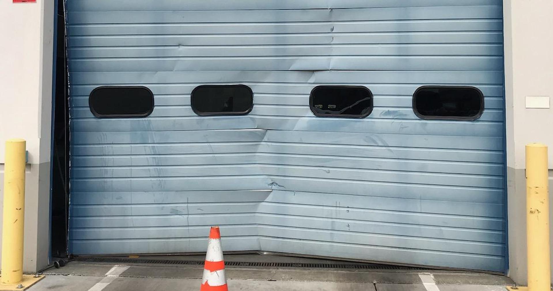 Loading dock sectional door crushed at the bottom