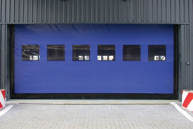 Blue high-speed fabric door on an industrial building