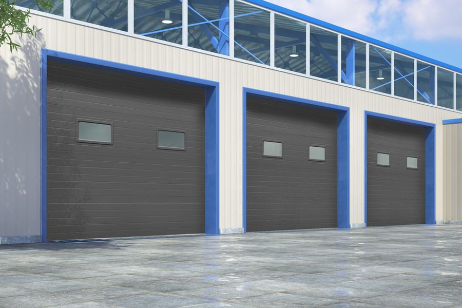 Three insulated sectional doors on a commercial building
